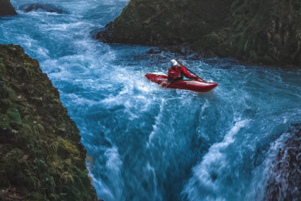 A kayaking person on a turbulent river